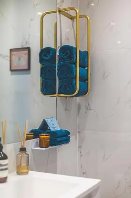 a bunch of towels on a shelf in a bathroom at Luxury MArylebone Village family home in Moffat