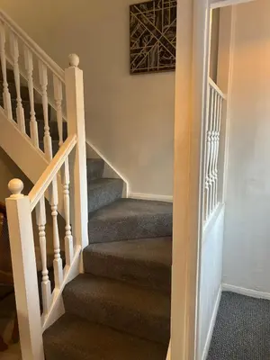 a stairway leading to the second floor of a home at Rochester Cosy Comfort near Shops and Restaurant in Moffat