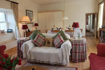a living room with a couch with pillows on it at Clachandubh Cottage in Lochgilphead