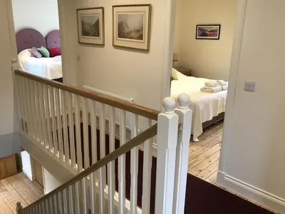 a hallway with a staircase leading to a bedroom at Ederline Farm Cottage in Lochgilphead