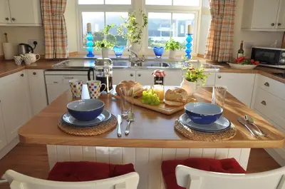 a kitchen with a wooden table with food on it at Finchairn Farmhouse in Lochgilphead