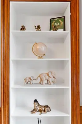 a white shelf with figurines of animals on it at Gardners Crescent in Edinburgh