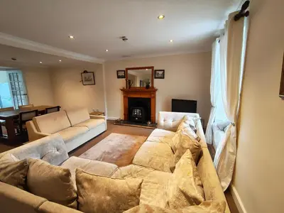 a living room with a couch and a fireplace at Fintry Inn in Fintry