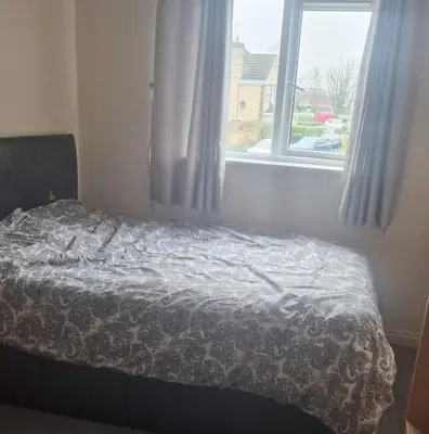 a bed in a bedroom with a window at Victory Room in Moffat
