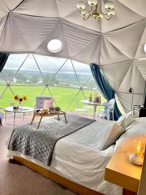 a bedroom with a large bed in a tent at The Dome at Midauchengowan in Lochwinnoch