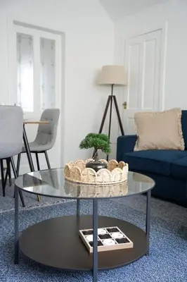 a living room with a table with a bonsai tree on it at Simpson House in Tillicoultry