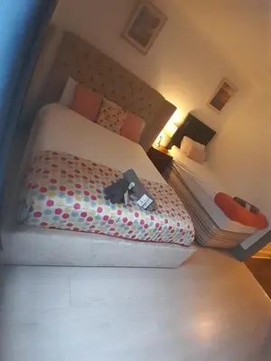 a bedroom with a bed with a teddy bear on it at Warm Central Apartment by Meadows 7 in Edinburgh