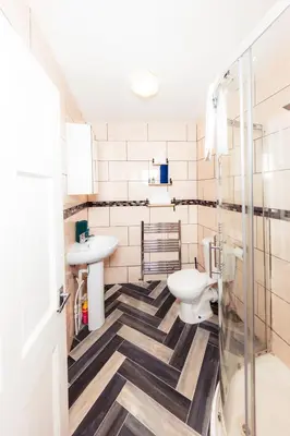 a bathroom with a toilet and a sink at Calm, Cosy & Central Apartment near Meadows 10 in Edinburgh