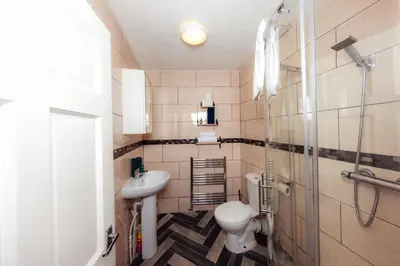 a bathroom with a sink and a toilet and a shower at Calm, Cosy & Central Apartment near Meadows 10 in Edinburgh