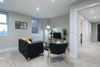 a living room with two chairs and a table at Chic 1Bed in Hull City Centre near Hull College in Moffat