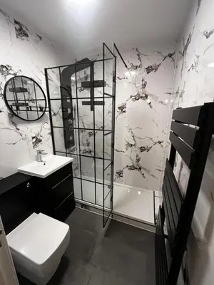 a bathroom with a toilet and a sink and a shower at Seaside Penthouse in Largs