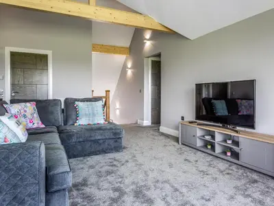 a living room with a couch and a flat screen tv at A'chrannchuir in Blackwaterfoot
