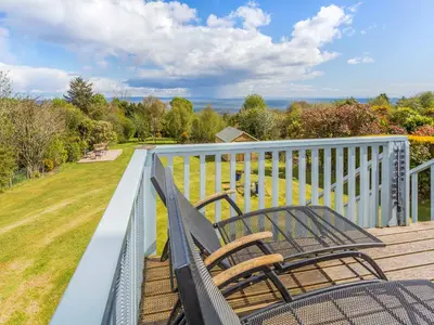 two benches on the deck of a house at Tanglewood in Whiting Bay
