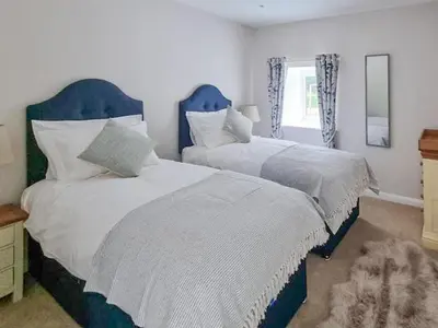 a bedroom with two beds and a window at Lady Farm in Girvan