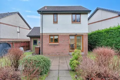 a house with a brick driveway in a yard at Stylish 3-Bed Home with Private Garden in Airdrie in Airdrie