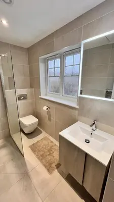 a bathroom with a sink and a toilet and a mirror at Modern 5 bedroom Getaway Free Parking in Hurlet