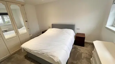 a small bedroom with a white bed and a window at Modern 5 bedroom Getaway Free Parking in Hurlet