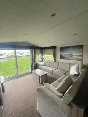 a large living room with a couch and a table at Shells at Sandylands in Stevenston
