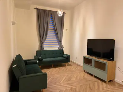 a living room with a couch and a television at Acorn Spacious Stay Glasgow in Glasgow