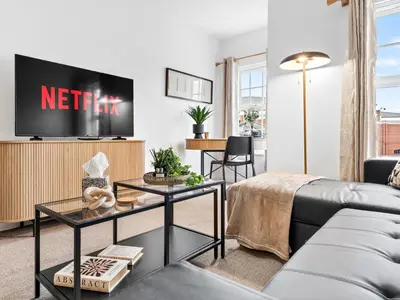 a living room with a couch and a tv at Modern 2-Bedroom Apartment with Free Parking in Warrington in Moffat