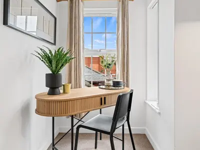 a table and chairs in a room with a window at Modern 2-Bedroom Apartment with Free Parking in Warrington in Moffat
