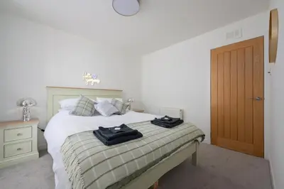 a bedroom with a bed with two towels on it at Historic 1BR Home in Culross Near Filming Sites in Culross