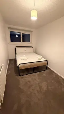 a small bedroom with a bed in a room at Spacious Glasgow Group Stay in Glasgow
