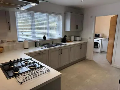 a kitchen with a stove and a counter top at Luxury 4BR Detached Exec Home in Cadzow