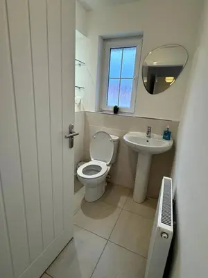 a bathroom with a toilet and a sink at Luxury 4BR Detached Exec Home in Cadzow