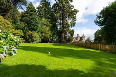 a yard with a soccer ball on the grass at Old Argyll House in Rashfield