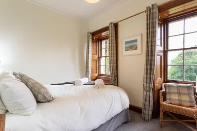 a bedroom with a bed and a window at Old Argyll House in Rashfield