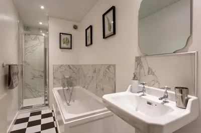 a bathroom with a sink and a shower and a tub at Old Argyll House in Rashfield