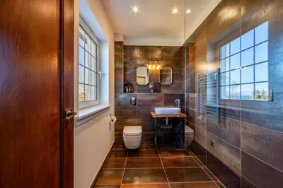 a bathroom with a toilet and a sink at Oban Bay Hall in Dunollie