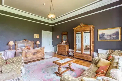a living room with a bed and a couch at Argyll Country House in Clachan