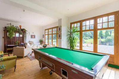 a large living room with a pool table at Argyll Country House in Clachan