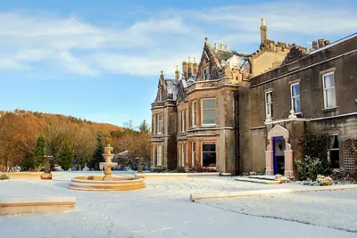 a large building with a fountain in front of it at Argyll Country House in Clachan
