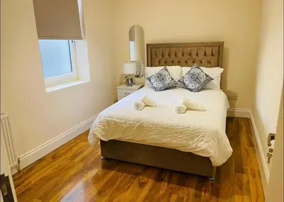 a bedroom with a bed with two towels on it at Glasgow City View Retreat in Glasgow