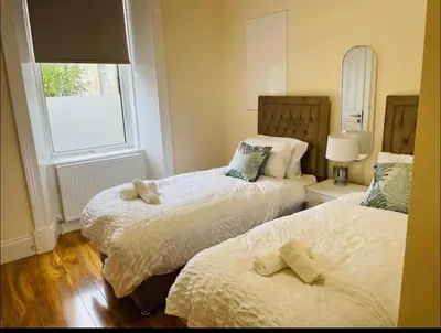 a bedroom with two beds and a window at Glasgow City View Retreat in Glasgow