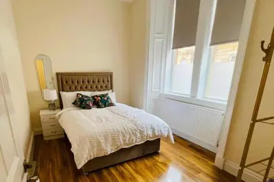a small bedroom with a bed and a window at Glasgow City View Retreat in Glasgow