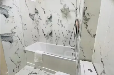 a bathroom with a shower and a tub and a toilet at Glasgow City View Retreat in Glasgow