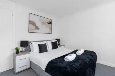 a bedroom with a bed with two towels on it at Contractor & Family Friendly House - Sleeps 8 - FREE Parking and Fast Wi-Fi in Uphall