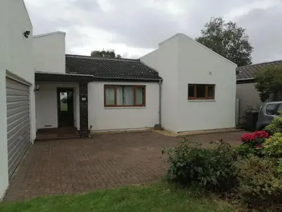a white house with a brick driveway at King size bed Direct bus to city center Silver in Edinburgh