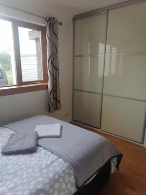 a bedroom with a bed and a large window at King size bed Direct bus to city center Silver in Edinburgh