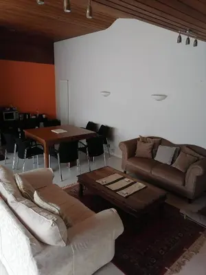 a living room with a couch and a table at King size bed Direct bus to city center Silver in Edinburgh
