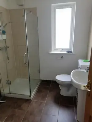 a bathroom with a shower and a toilet and a sink at King size bed Direct bus to city center Silver in Edinburgh