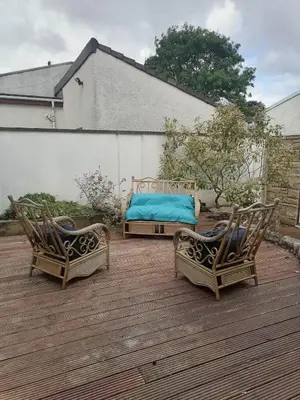 two chairs and a bed on a wooden deck at King size bed Direct bus to city center Silver in Edinburgh