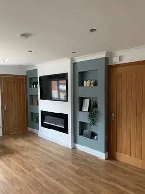 a living room with a fireplace and a tv at Fairway House- Stylish refurbished property in Moffat