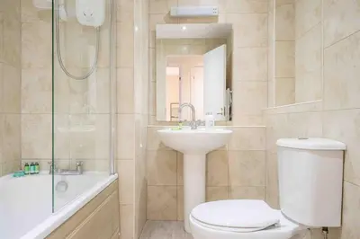 a bathroom with a toilet and a sink and a shower at Tranquil 2 Bed Flat, Free Parking, near Murrayfield & City Centre in Edinburgh