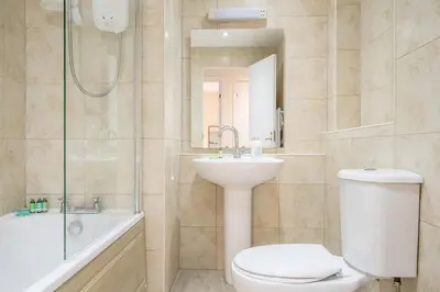 a bathroom with a toilet and a sink and a shower at Tranquil 2 Bed Flat, Free Parking, near Murrayfield & City Centre in Edinburgh