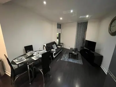 a living room with a table and chairs and a couch at City centre stylish apartment in Glasgow
